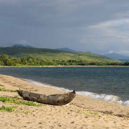 Tanzania, Malawi lake is the Worlds longest and second deepest fresh water lake, it is also one of the oldest lakes on the planet. The picture presents beautiful sand beach and traditional dugout canoe