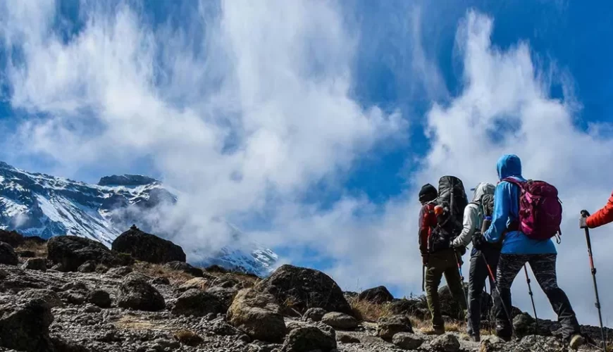 Trekkers walking toward the ice capped summit of Mount Kilimanjaro in Tanzania